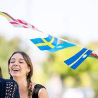Students talking under flag garland